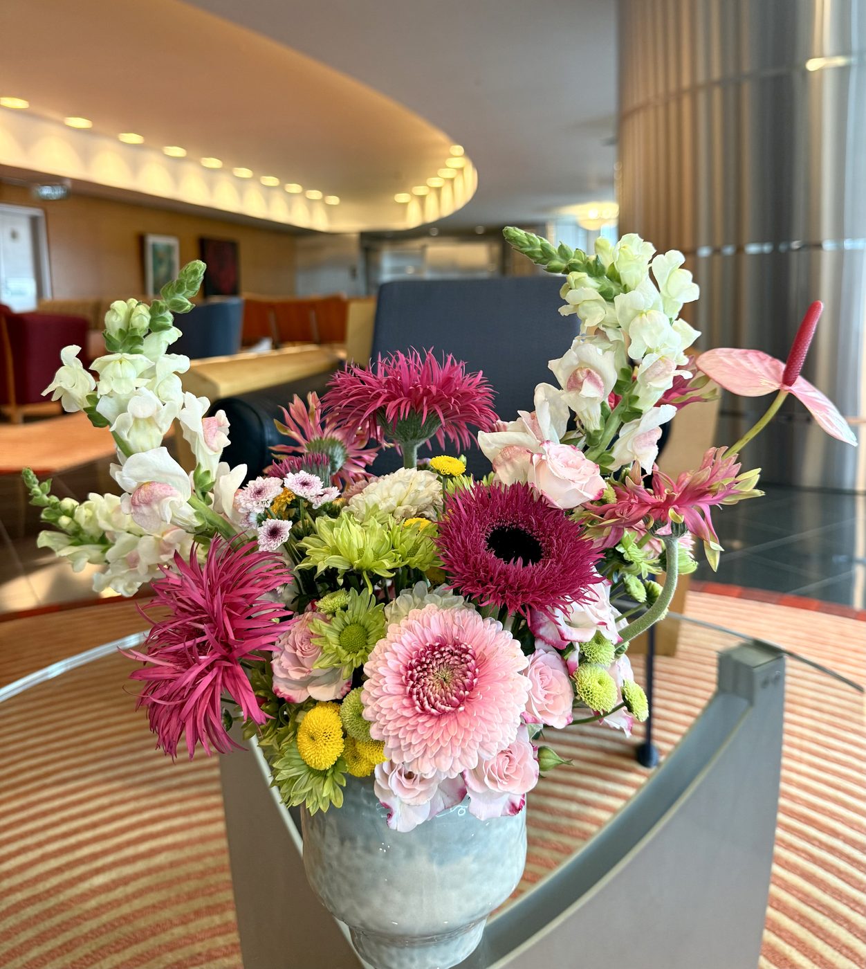 Bright pink gerbera and snapdragon arrangement